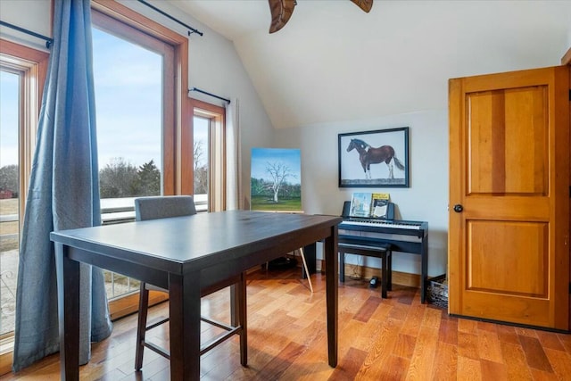 interior space featuring lofted ceiling, ceiling fan, and light wood-style flooring