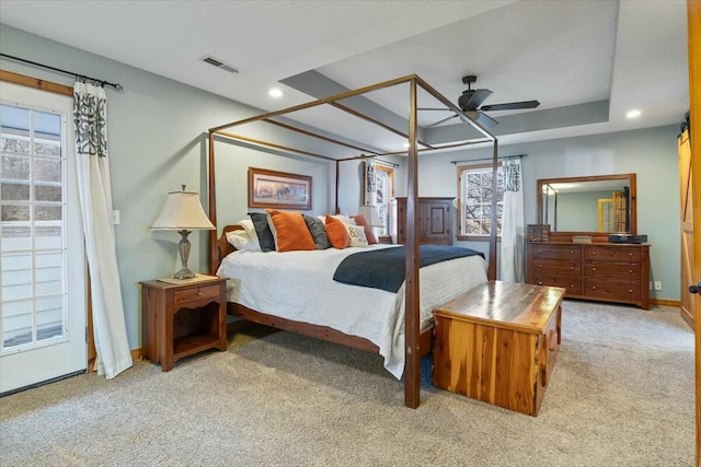 bedroom with recessed lighting, a ceiling fan, visible vents, a tray ceiling, and carpet