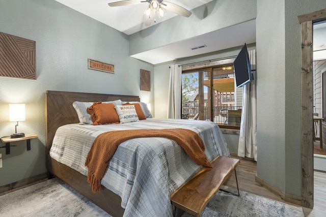 bedroom featuring baseboards, visible vents, ceiling fan, wood finished floors, and access to outside