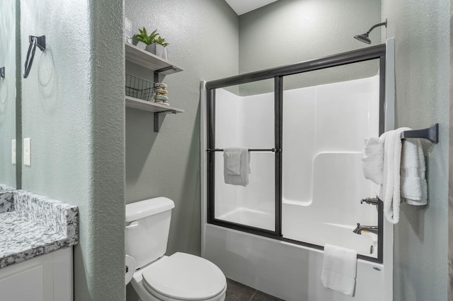 full bathroom with a textured wall, toilet, shower / bath combination with glass door, vanity, and tile patterned floors