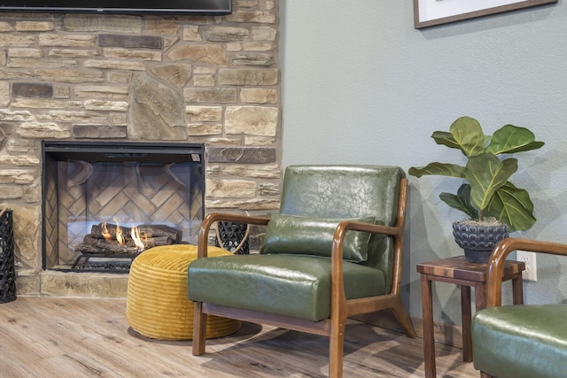 sitting room featuring a fireplace and wood finished floors