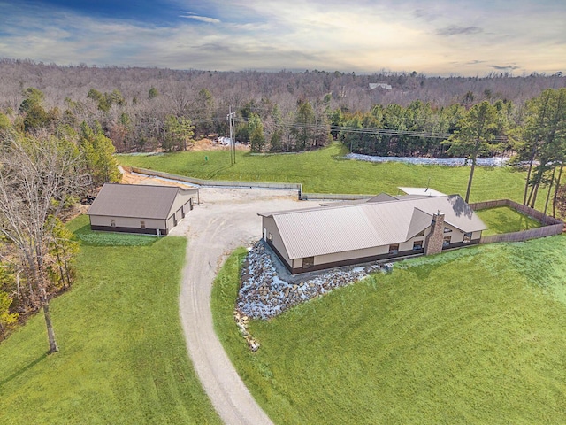 drone / aerial view with a wooded view