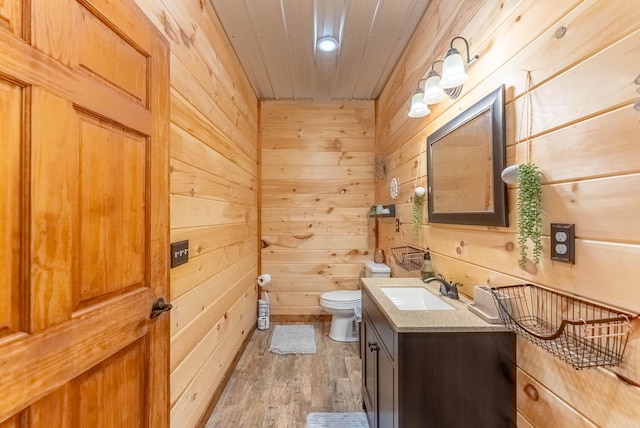 80 Serenity Ct, Gepp, AR 72538 - bathroom with wooden walls, toilet, wooden ceiling, wood finished floors, and vanity