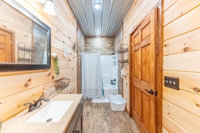 80 Serenity Ct, Gepp, AR 72538 - bathroom featuring shower / tub combo, wood walls, vanity, and wood finished floors