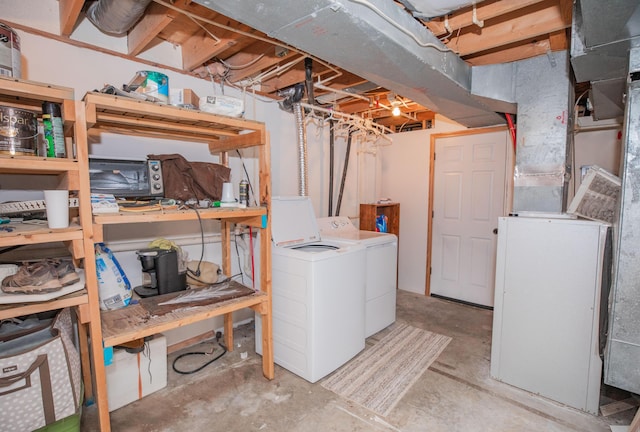 unfinished basement featuring independent washer and dryer