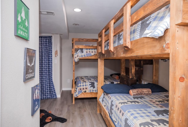 bedroom featuring recessed lighting, wood finished floors, visible vents, and baseboards