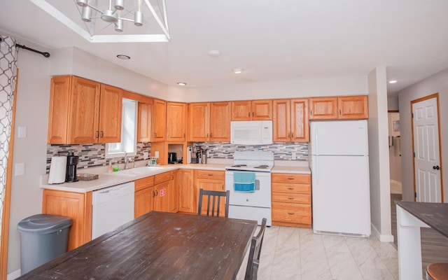 kitchen featuring marble finish floor, light countertops, backsplash, a sink, and white appliances