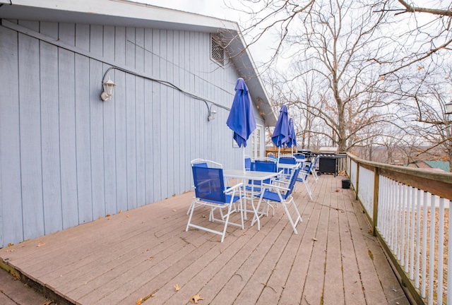 wooden deck featuring outdoor dining space