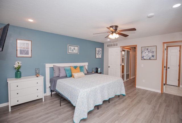 bedroom with recessed lighting, visible vents, baseboards, and wood finished floors