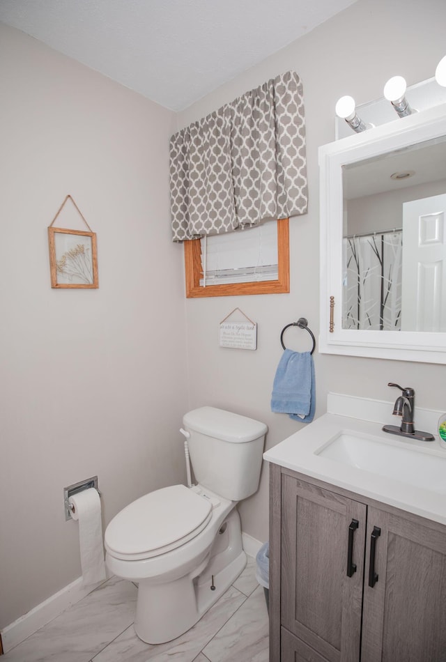 full bathroom with marble finish floor, baseboards, vanity, and toilet