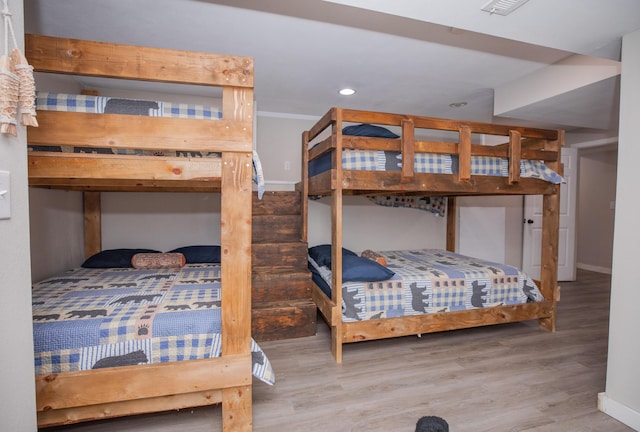 bedroom featuring recessed lighting, baseboards, and wood finished floors