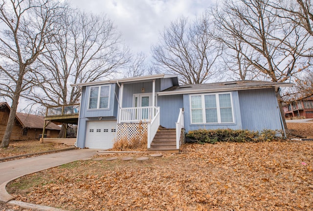 split level home with a garage and concrete driveway