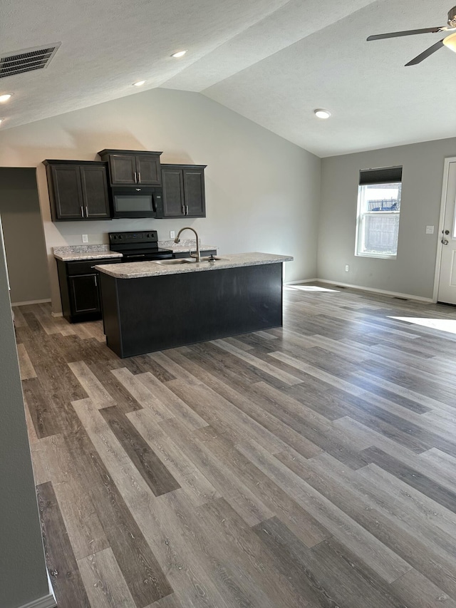 kitchen with visible vents, lofted ceiling, open floor plan, dark wood-type flooring, and black appliances