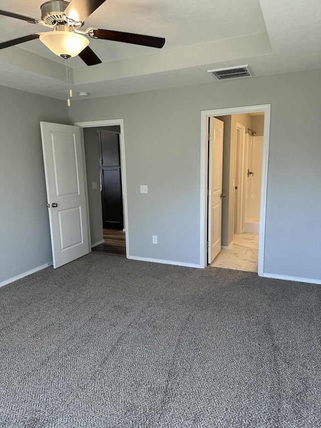 unfurnished bedroom featuring carpet, visible vents, ceiling fan, and baseboards