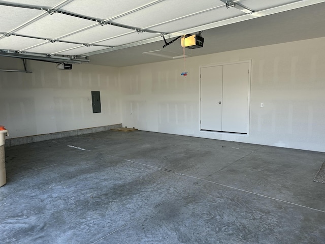 garage featuring electric panel and a garage door opener