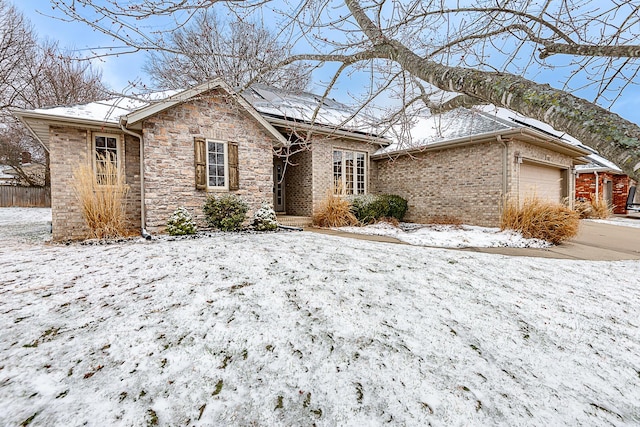 single story home with stone siding, brick siding, and fence