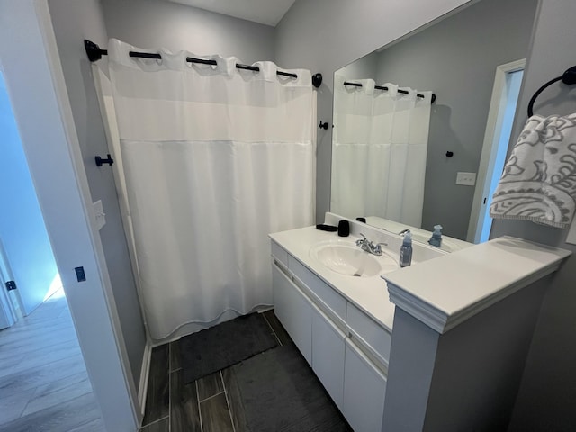 full bath featuring vanity, curtained shower, and wood finish floors