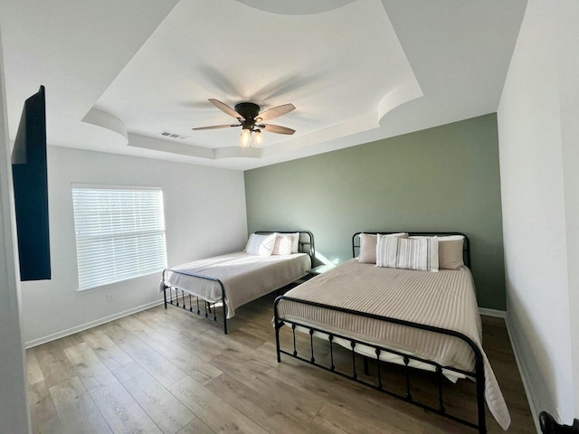 280 Woodland Dr Unit 2D, Branson, MO 65616 - bedroom with a raised ceiling, baseboards, wood finished floors, and ceiling fan