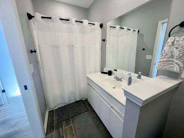 280 Woodland Dr Unit 2D, Branson, MO 65616 - full bathroom featuring vanity, wood finished floors, and a shower with shower curtain