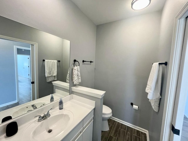 280 Woodland Dr Unit 2D, Branson, MO 65616 - bathroom featuring toilet, wood finished floors, baseboards, and vanity