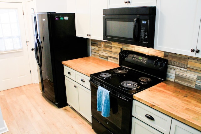 280 Woodland Dr Unit 2D, Branson, MO 65616 - kitchen with wooden counters, black appliances, decorative backsplash, light wood finished floors, and white cabinets