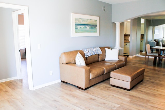 280 Woodland Dr Unit 2D, Branson, MO 65616 - living area featuring decorative columns, light wood-style flooring, and baseboards