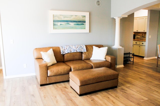280 Woodland Dr Unit 2D, Branson, MO 65616 - living area featuring decorative columns, light wood-style flooring, and baseboards