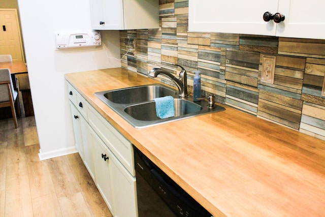 280 Woodland Dr Unit 2D, Branson, MO 65616 - kitchen with a sink, dishwasher, backsplash, white cabinetry, and light wood-style floors