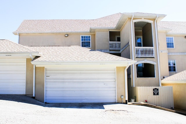 280 Woodland Dr Unit 2D, Branson, MO 65616 - view of front facade with a shingled roof, stucco siding, and a garage