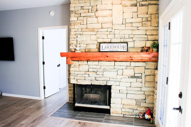 280 Woodland Dr Unit 2D, Branson, MO 65616 - detailed view of a stone fireplace, wood finished floors, and baseboards