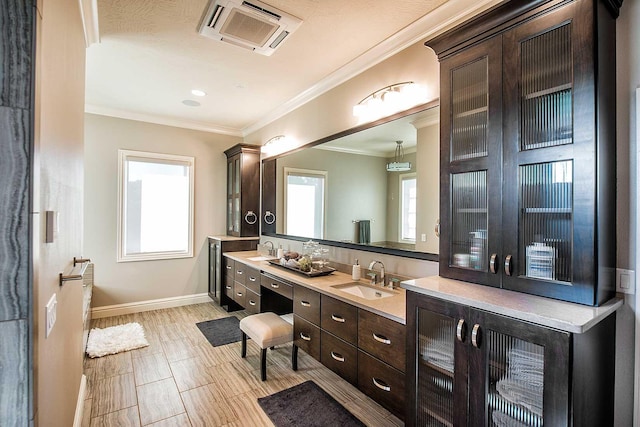 full bath with baseboards, vanity, and crown molding