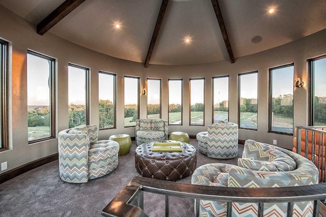 sunroom / solarium with lofted ceiling with beams and a healthy amount of sunlight