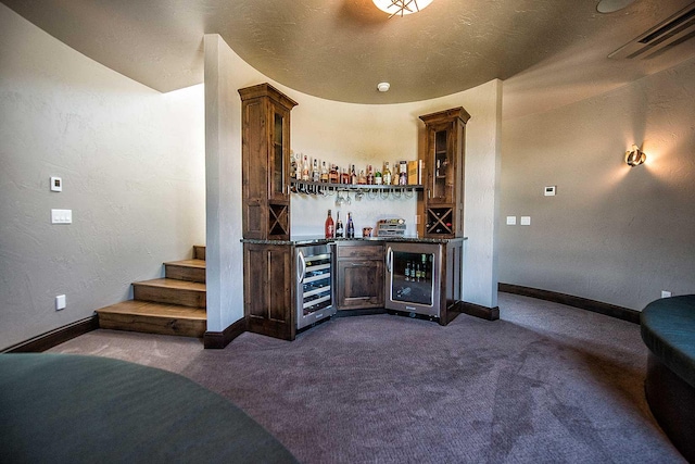 bar with a dry bar, beverage cooler, visible vents, and dark carpet