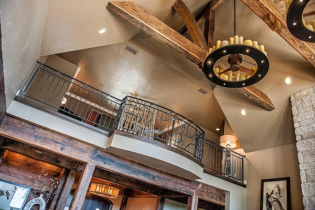 stairs with high vaulted ceiling, beamed ceiling, visible vents, and recessed lighting