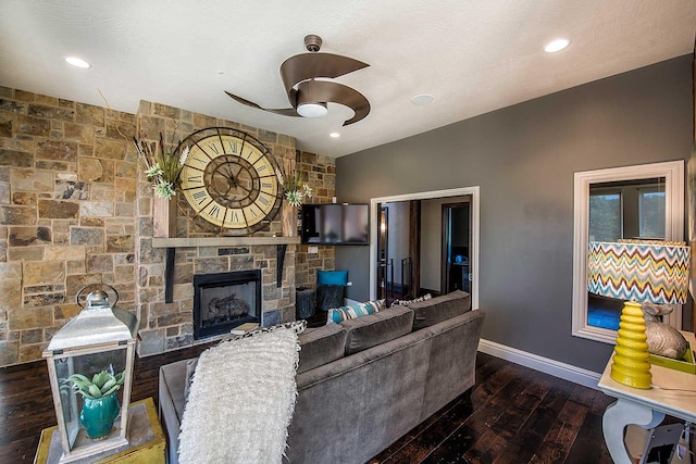 living area featuring recessed lighting, a fireplace, wood finished floors, a ceiling fan, and baseboards