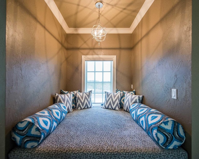 bedroom with a chandelier, carpet floors, ornamental molding, and a textured wall