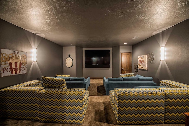 cinema room with carpet floors, a textured wall, and a textured ceiling