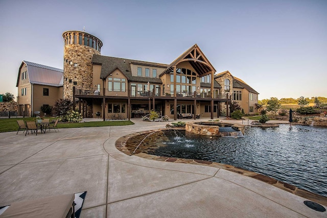 back of property featuring a patio area and a pool with connected hot tub