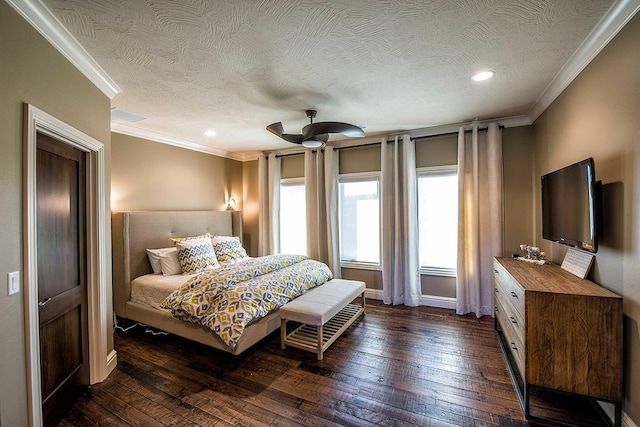 bedroom featuring a textured ceiling, ornamental molding, dark wood-style flooring, and baseboards