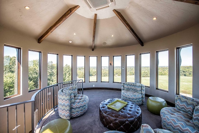 sunroom / solarium featuring vaulted ceiling with beams and visible vents