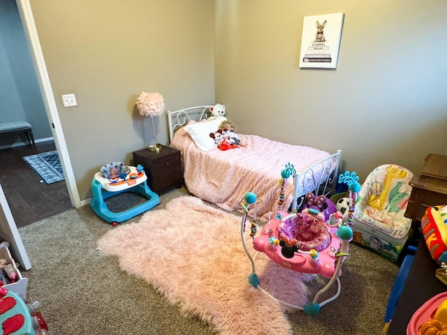 bedroom with baseboards and carpet flooring