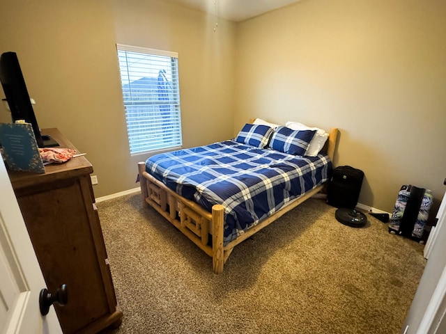 bedroom with carpet floors and baseboards