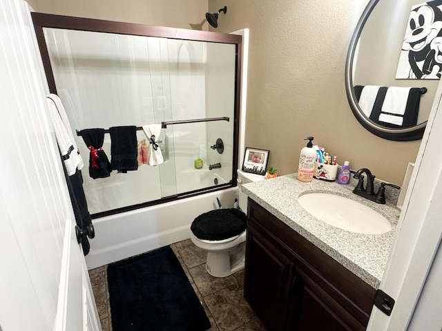 full bath with a textured wall, toilet, enclosed tub / shower combo, vanity, and tile patterned flooring