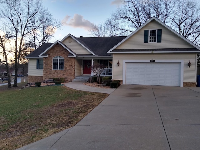 view of front of property with covered porch, concrete driveway, and a front yard