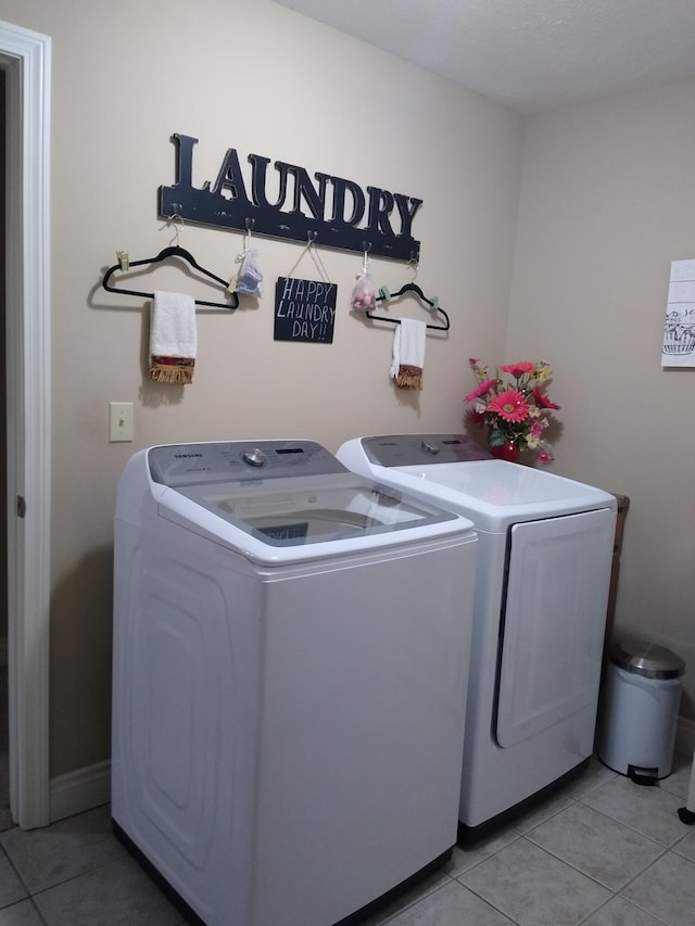 laundry area with laundry area, light tile patterned floors, and separate washer and dryer