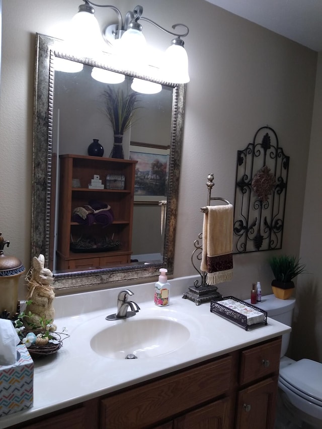 bathroom with toilet and vanity