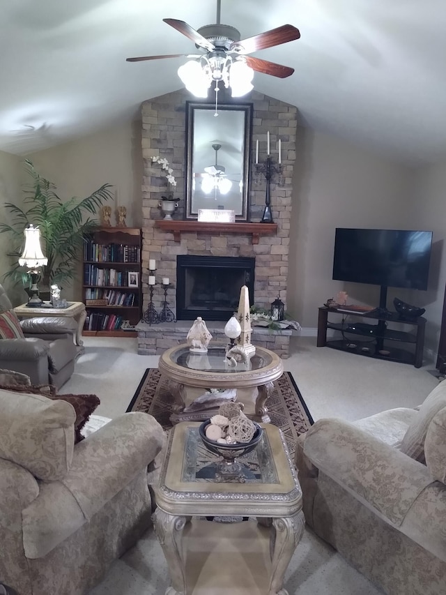 living area featuring vaulted ceiling, ceiling fan, a fireplace, and carpet flooring