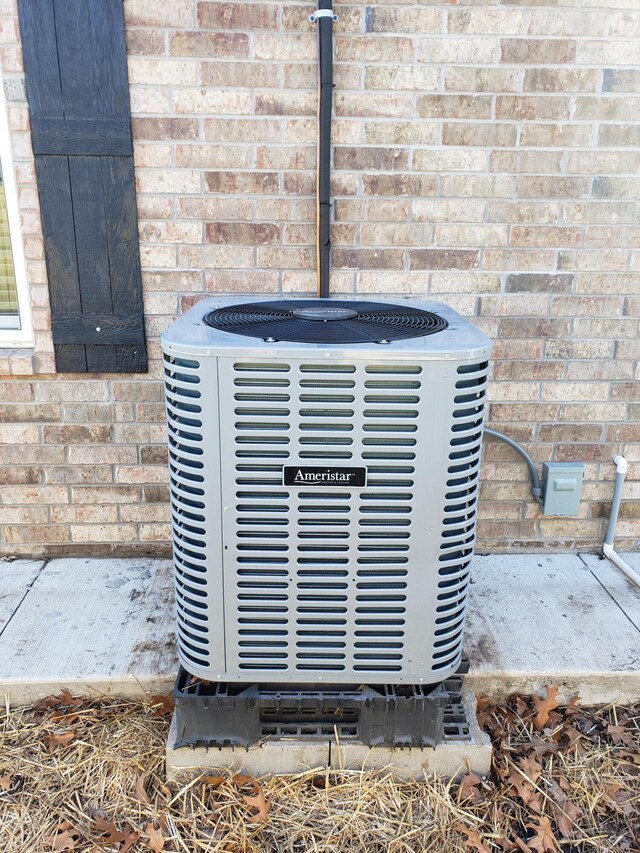 exterior details with cooling unit and brick siding