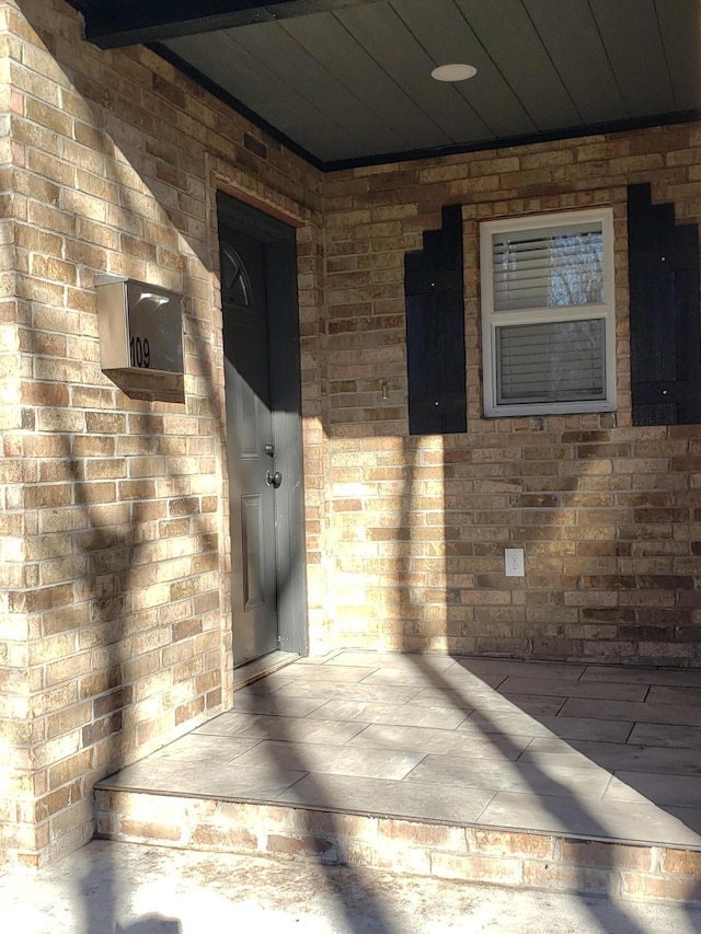 entrance to property with brick siding