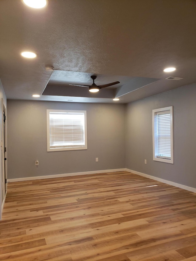 spare room featuring recessed lighting, baseboards, visible vents, and light wood finished floors